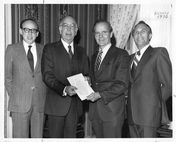 Bass, Huberman and Proxmire standing together with signed document